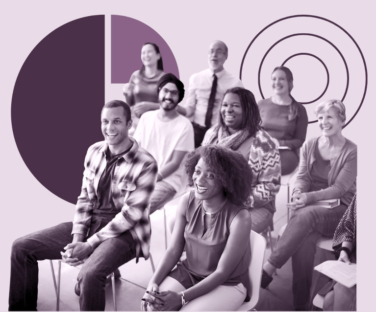 People sitting in chairs smiling listening to a presentation.
