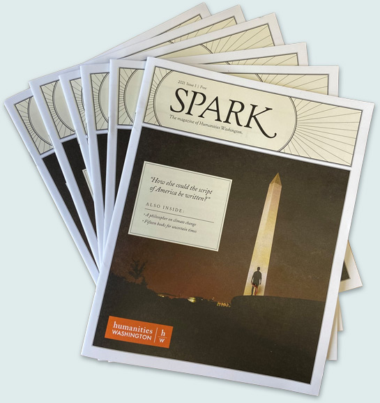 Copies of Spark magazine stacked on top of one another