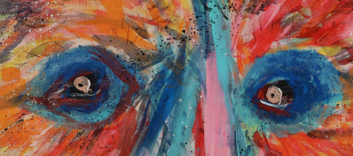 A colorful painting of a pair of bear eyes.